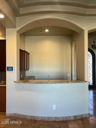 a kitchen with stainless steel appliances granite countertop wooden cabinets sink and refrigerator