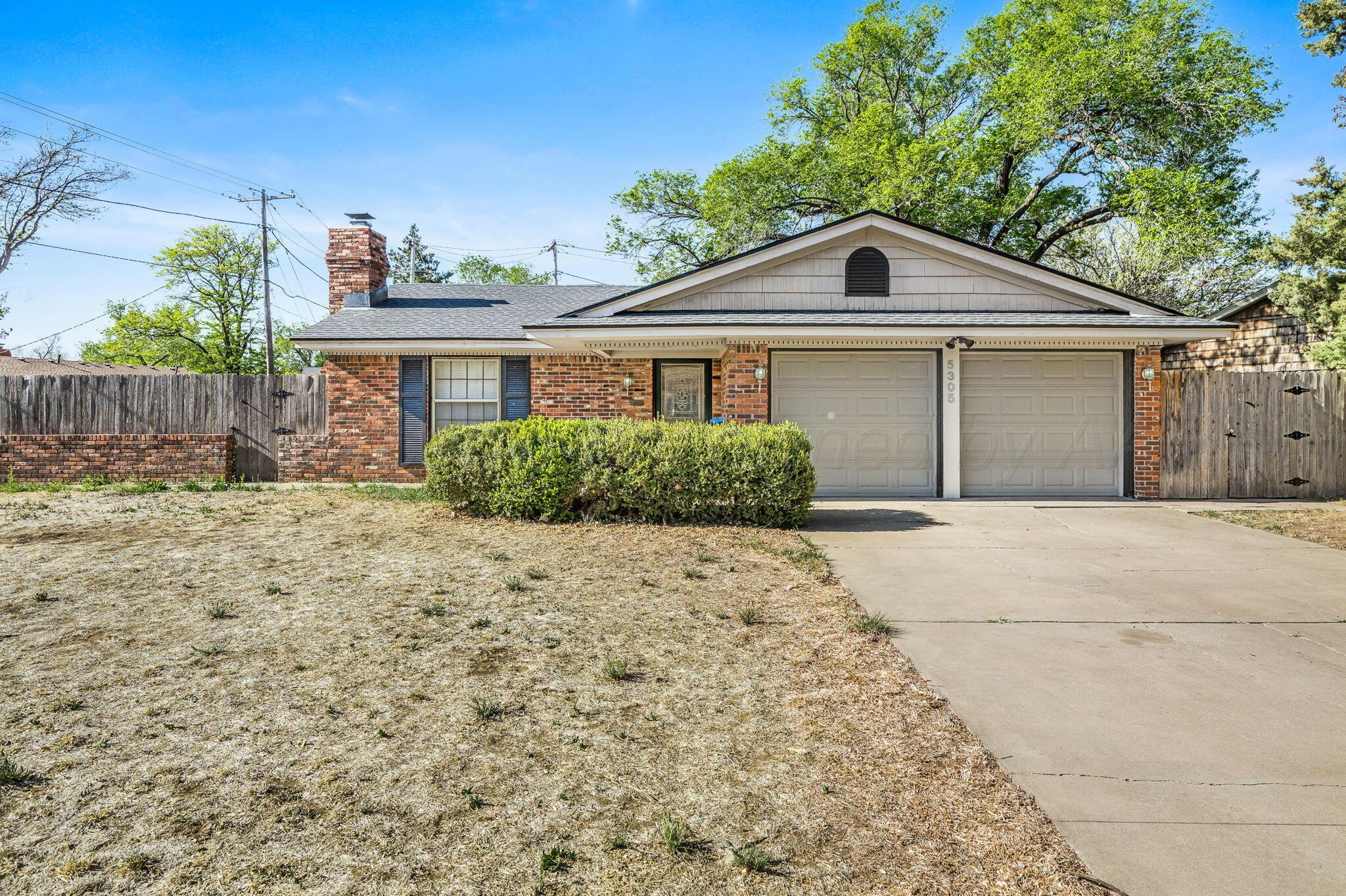 5305 Randolph Road Amarillo, TX 79106 - Photo 1 of 20 a front view of a house with a yard and garage