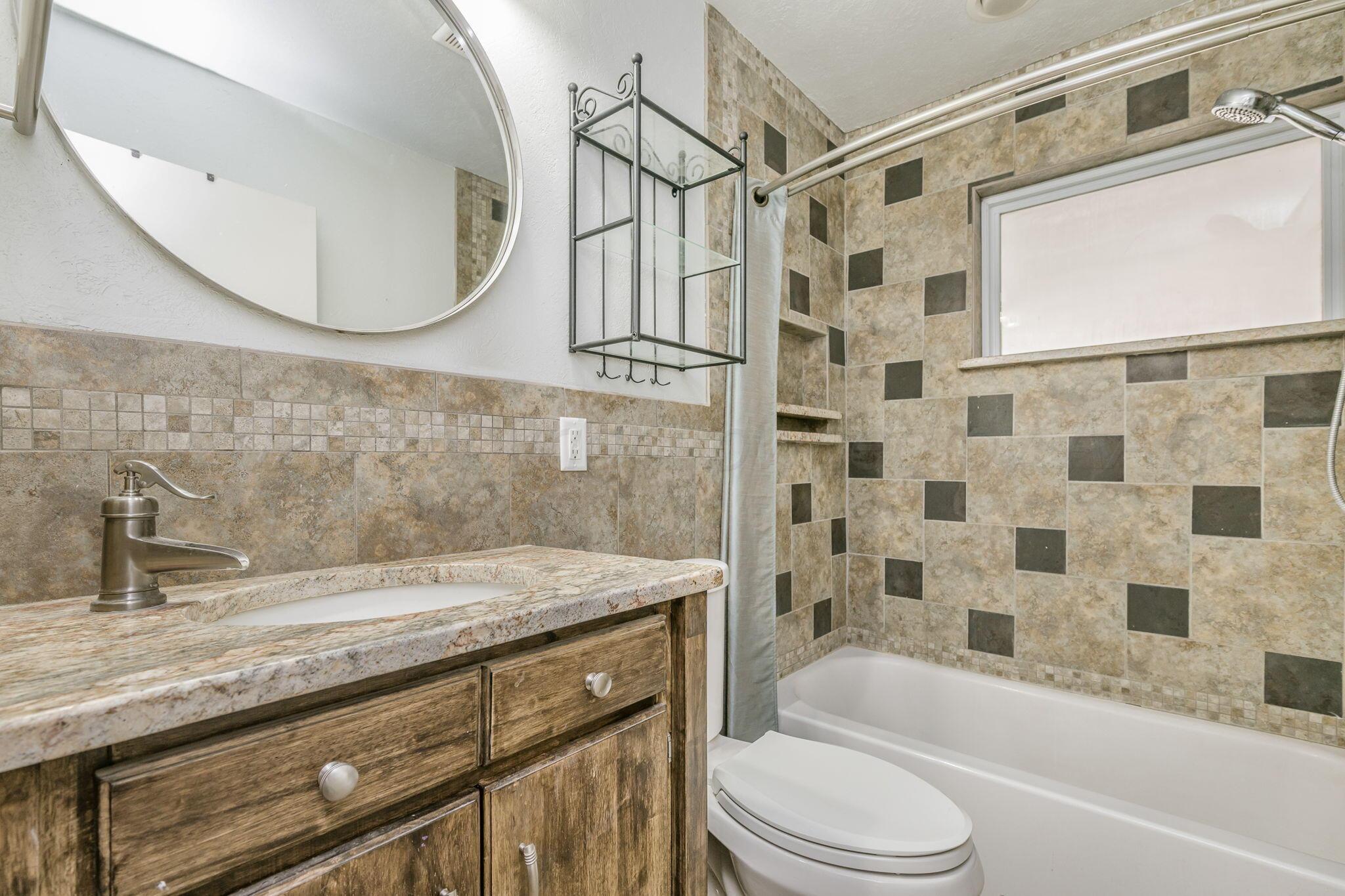 5305 Randolph Road Amarillo, TX 79106 - Photo 11 of 20 a bathroom with a sink a toilet and shower