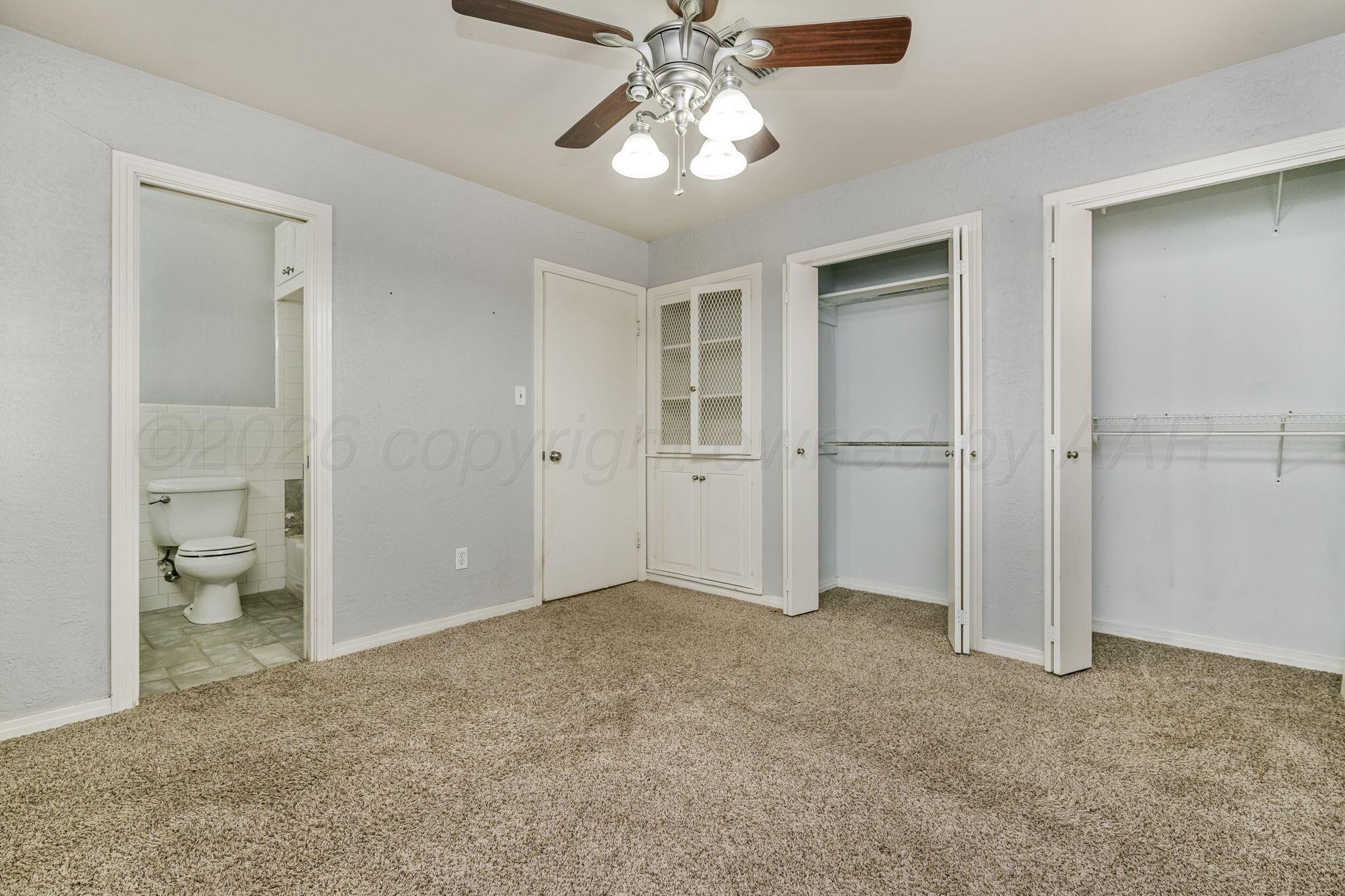 5305 Randolph Road Amarillo, TX 79106 - Photo 12 of 20 wooden floor in an empty room and a bathroom
