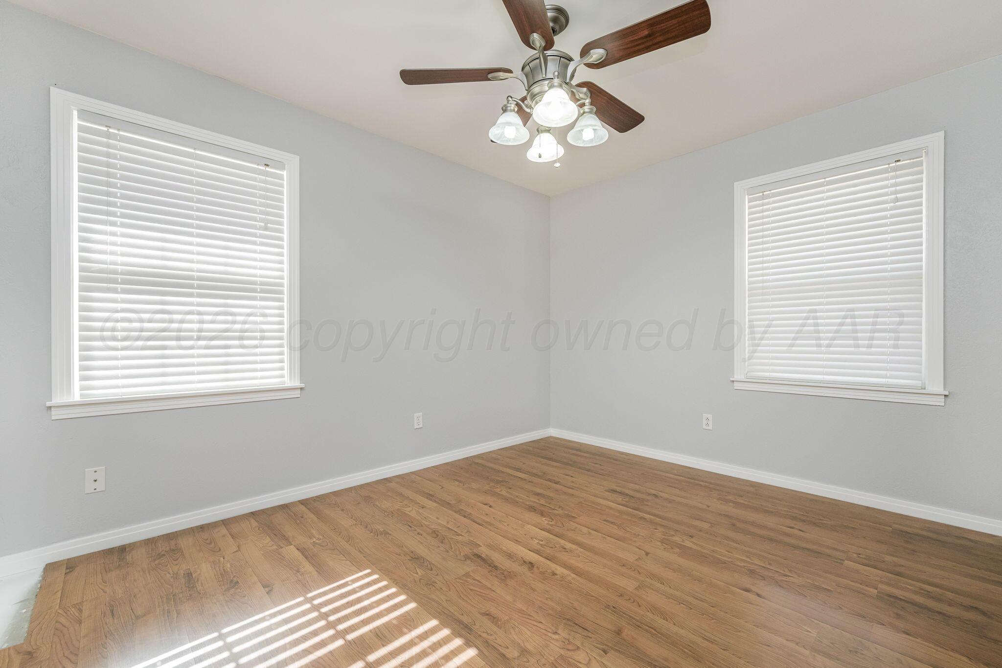 5305 Randolph Road Amarillo, TX 79106 - Photo 13 of 20 a view of a room with wooden floor and windows