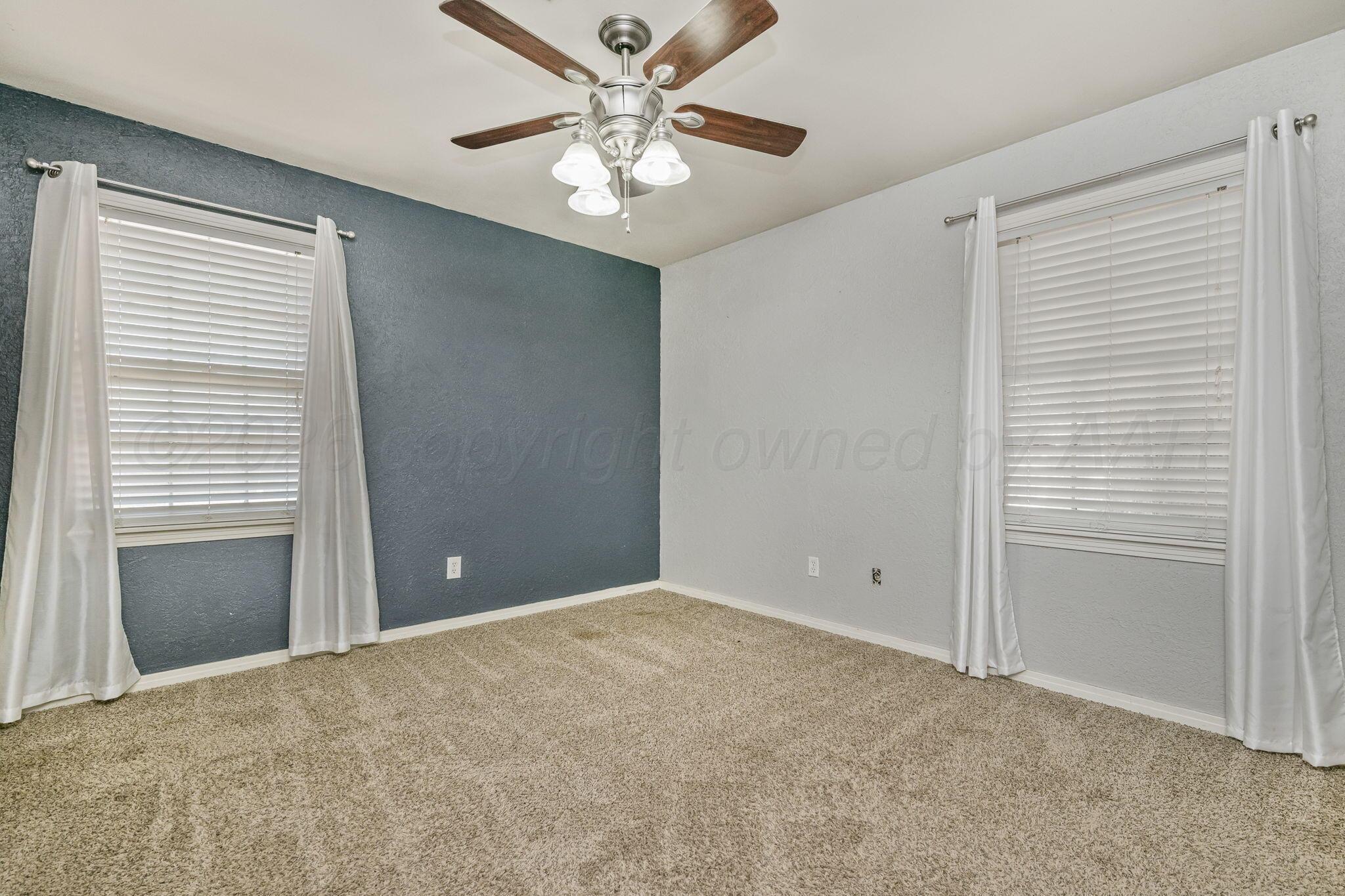 5305 Randolph Road Amarillo, TX 79106 - Photo 9 of 20 a view of an empty room with a window