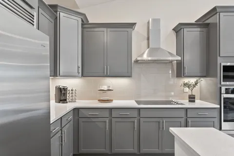 a kitchen with a sink a stove and cabinets