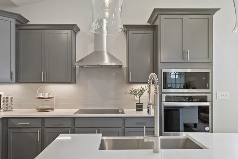 a kitchen with a stove and a white cabinet