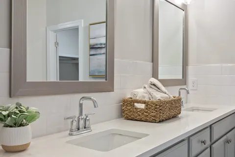 a spacious bathroom with a double vanity sink mirror and toilet
