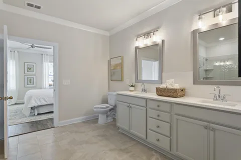 a bathroom with a sink a toilet and a mirror