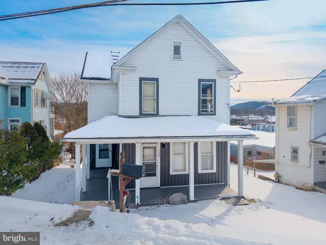 a front view of a house with a yard and glass windows