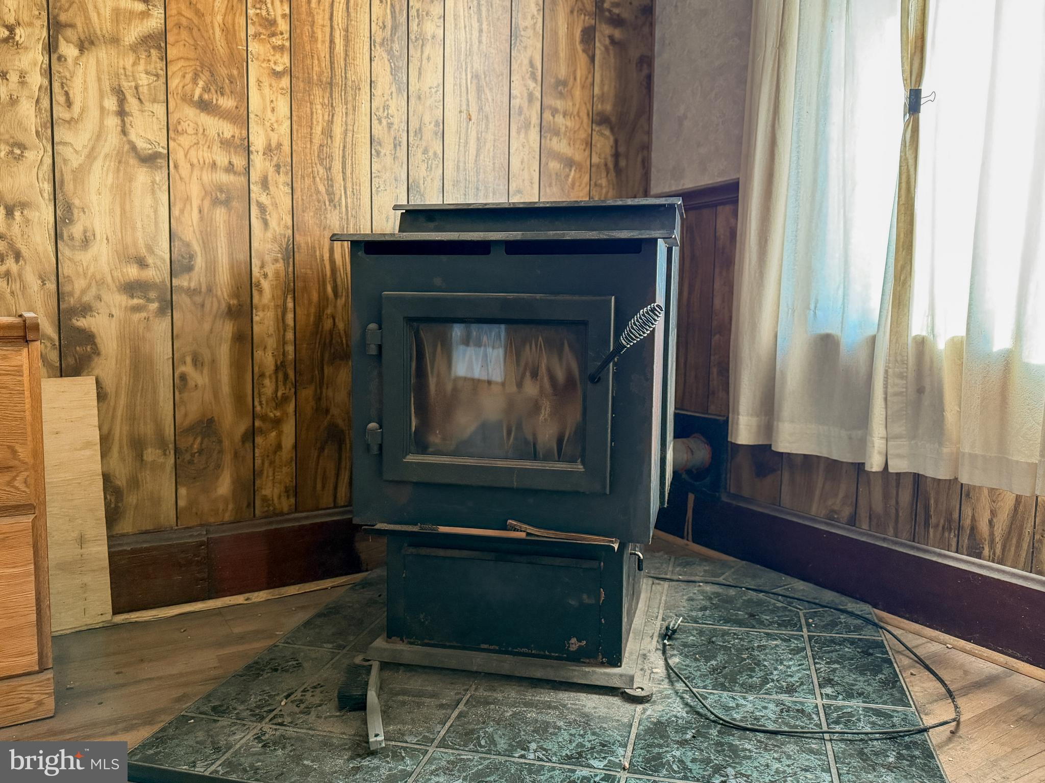 130 East 1st Street Everett, PA 15537 - Photo 12 of 39 a living room with a fireplace and a glass door shower