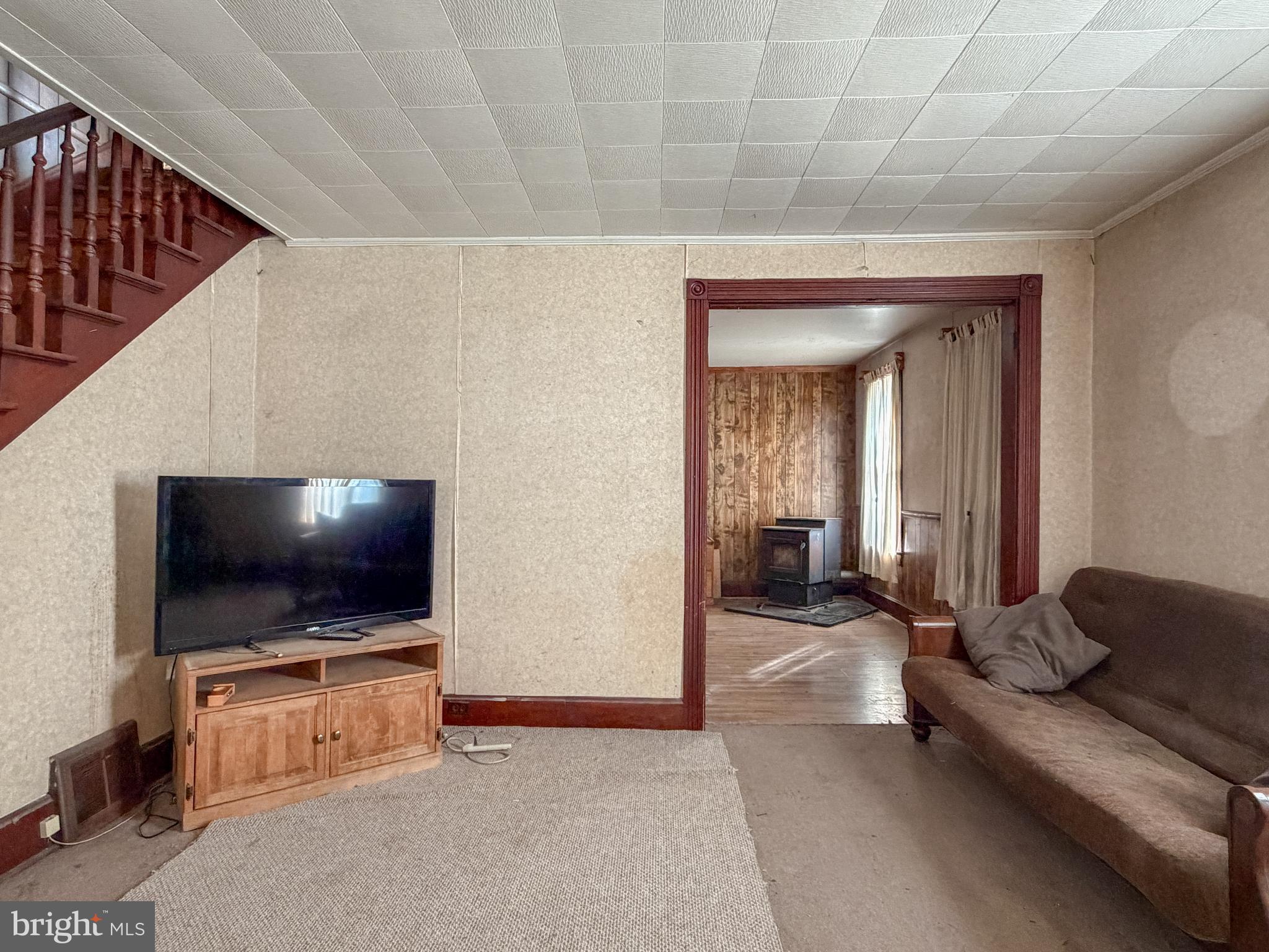 130 East 1st Street Everett, PA 15537 - Photo 16 of 39 a living room with furniture and a flat screen tv