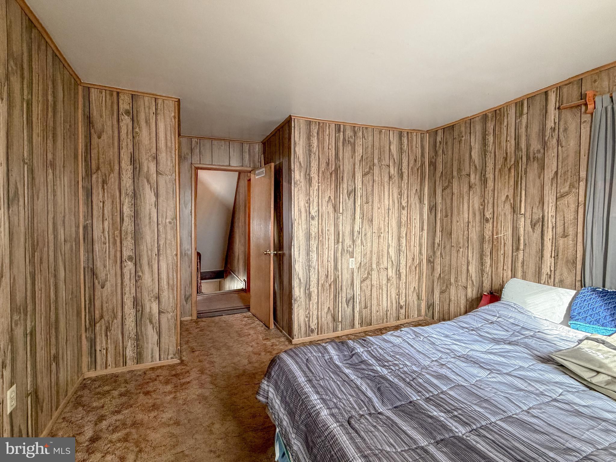 130 East 1st Street Everett, PA 15537 - Photo 18 of 39 a bedroom with a bed and a mirror