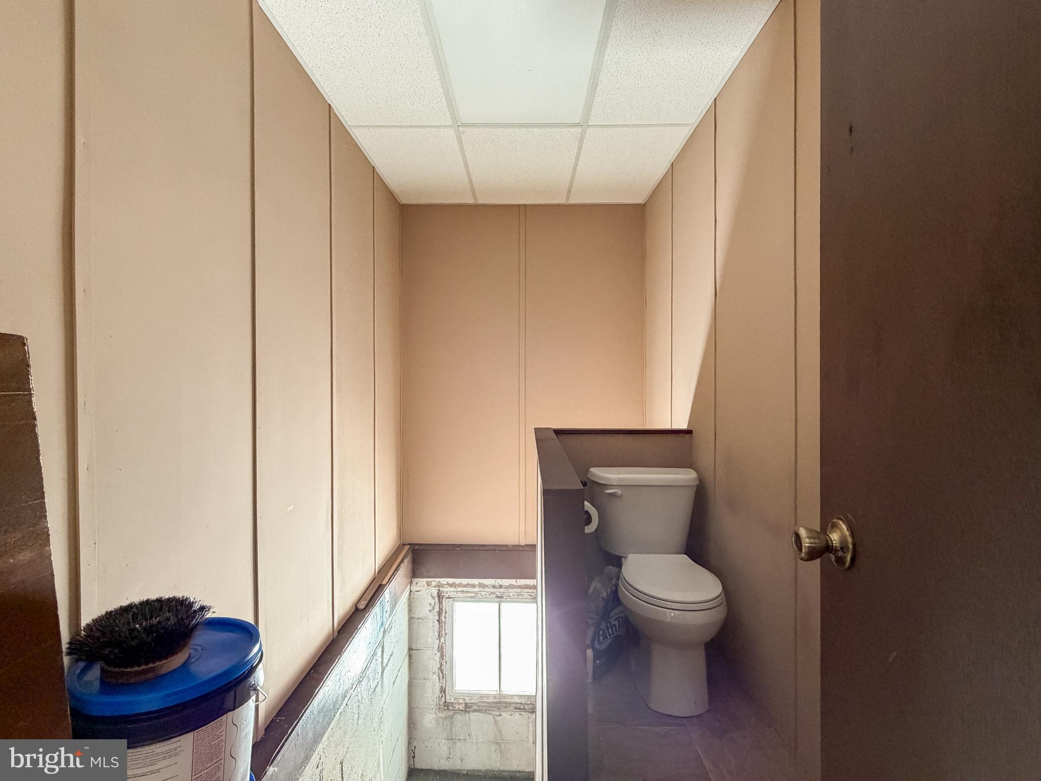 130 East 1st Street Everett, PA 15537 - Photo 29 of 39 a bathroom with a toilet a sink and a window