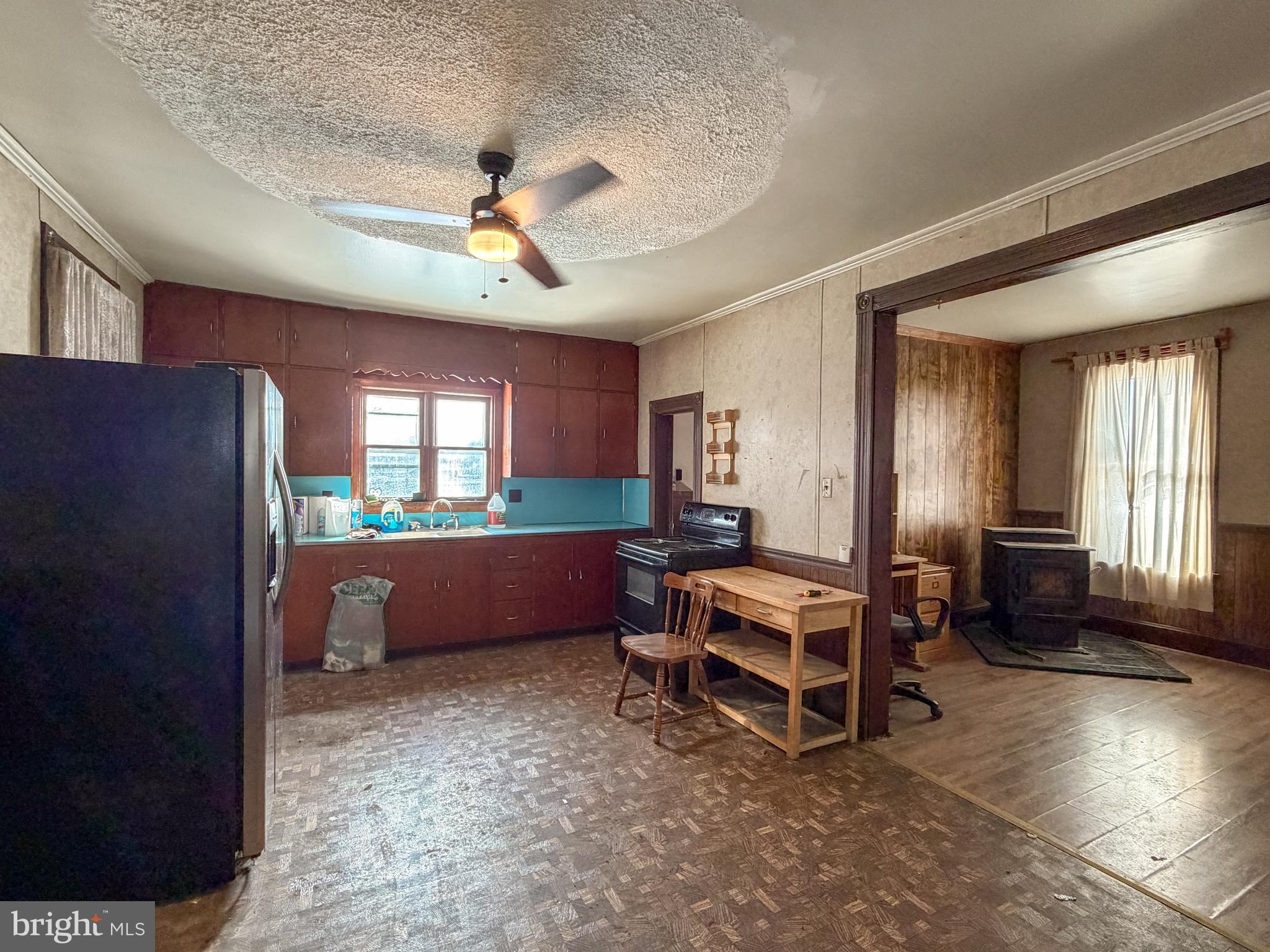 130 East 1st Street Everett, PA 15537 - Photo 9 of 39 a room with furniture a chandelier fan and windows
