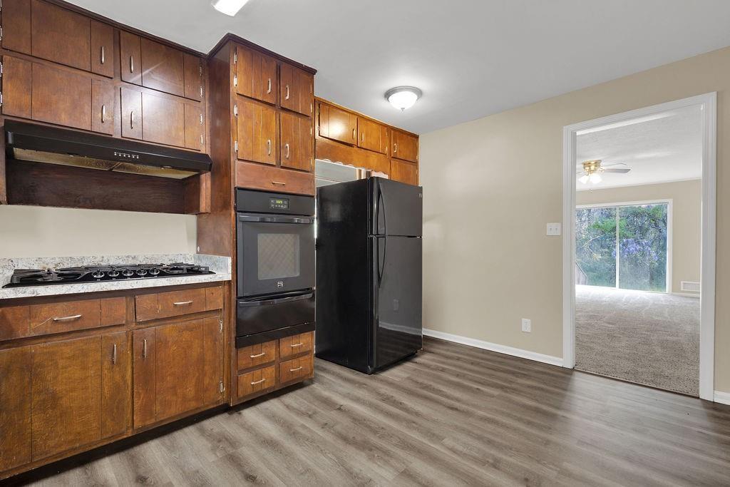 2739 Council Street Lithonia, GA 30058 - Photo 12 of 31 a kitchen with stainless steel appliances granite countertop a refrigerator and a stove