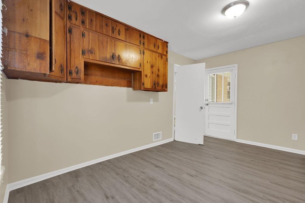 2739 Council Street Lithonia, GA 30058 - Photo 17 of 31 a view of an empty room with wooden floor and cabinets
