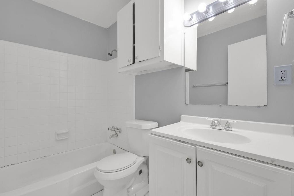 2739 Council Street Lithonia, GA 30058 - Photo 21 of 31 a bathroom with a sink a toilet and a mirror