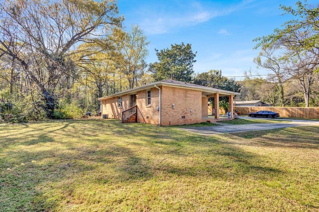 2739 Council Street Lithonia, GA 30058 - Photo 31 of 31 a front view of a house with a yard and garage