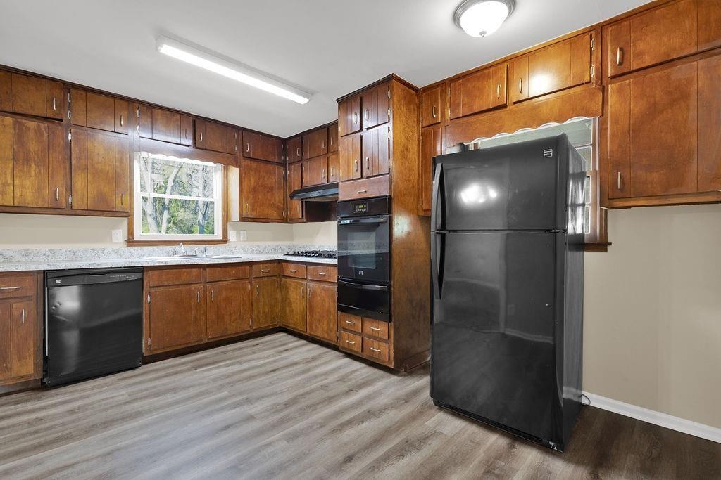 2739 Council Street Lithonia, GA 30058 - Photo 9 of 31 a kitchen with a refrigerator and a sink