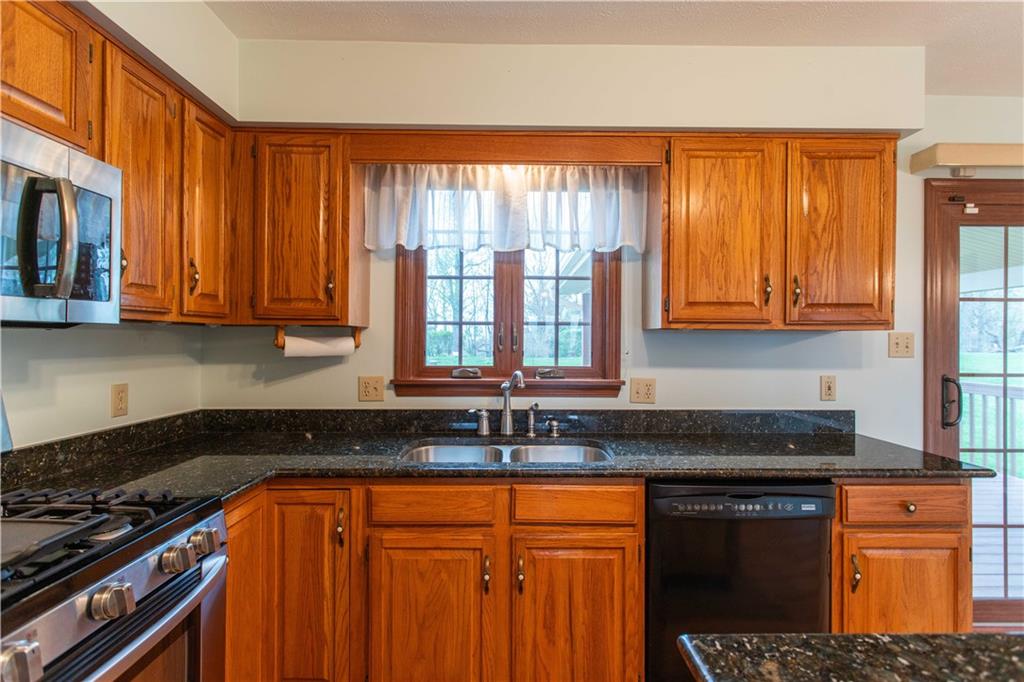 128 Moffett Run Road Aliquippa, PA 15001 - Photo 16 of 48 a kitchen with stainless steel appliances granite countertop a stove a sink dishwasher and a microwave oven with granite countertops
