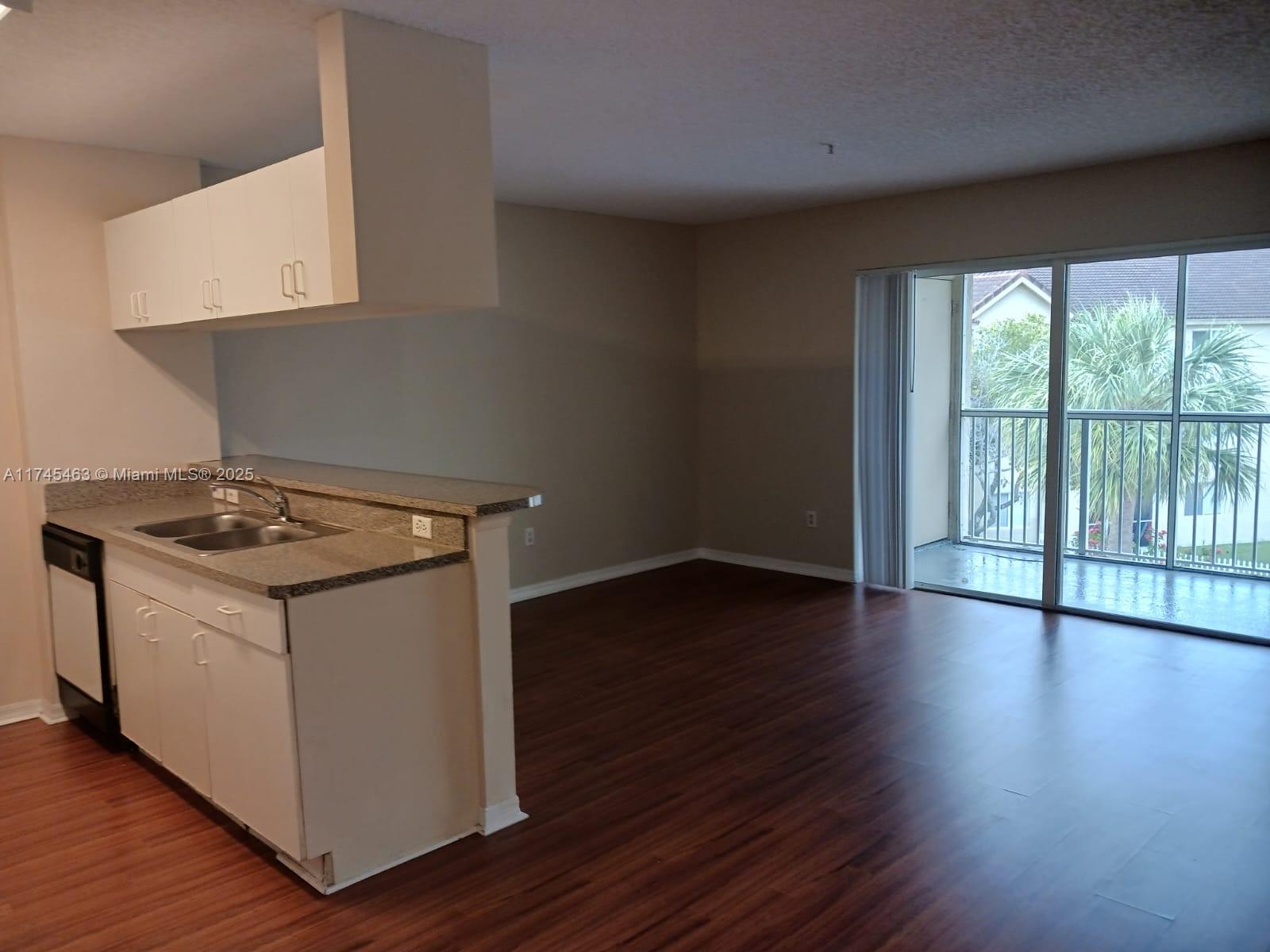Pinehurst Club Condominiums Hollywood, FL 33021 - Photo 12 of 22 a view of utility room with wooden floor and windows