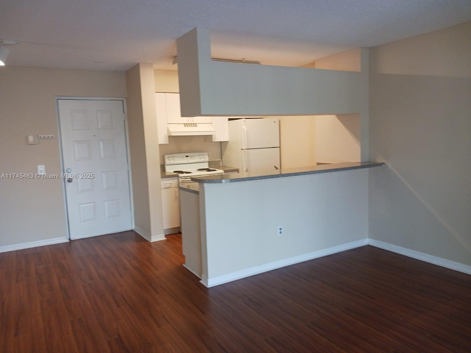 Pinehurst Club Condominiums Hollywood, FL 33021 - Photo 20 of 22 a view of a kitchen with wooden floor and electronic appliances