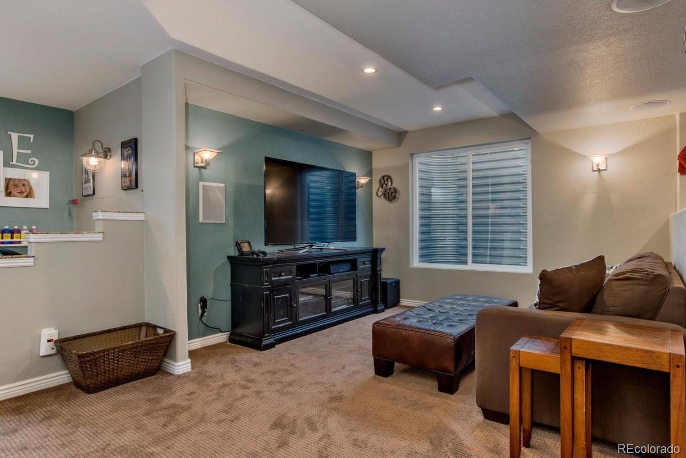 10685 Wynspire Road Highlands Ranch, CO 80130 - Photo 16 of 29 a bedroom with a bed and a flat screen television
