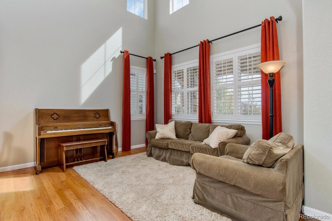 10685 Wynspire Road Highlands Ranch, CO 80130 - Photo 2 of 29 a living room with furniture and a floor to ceiling window