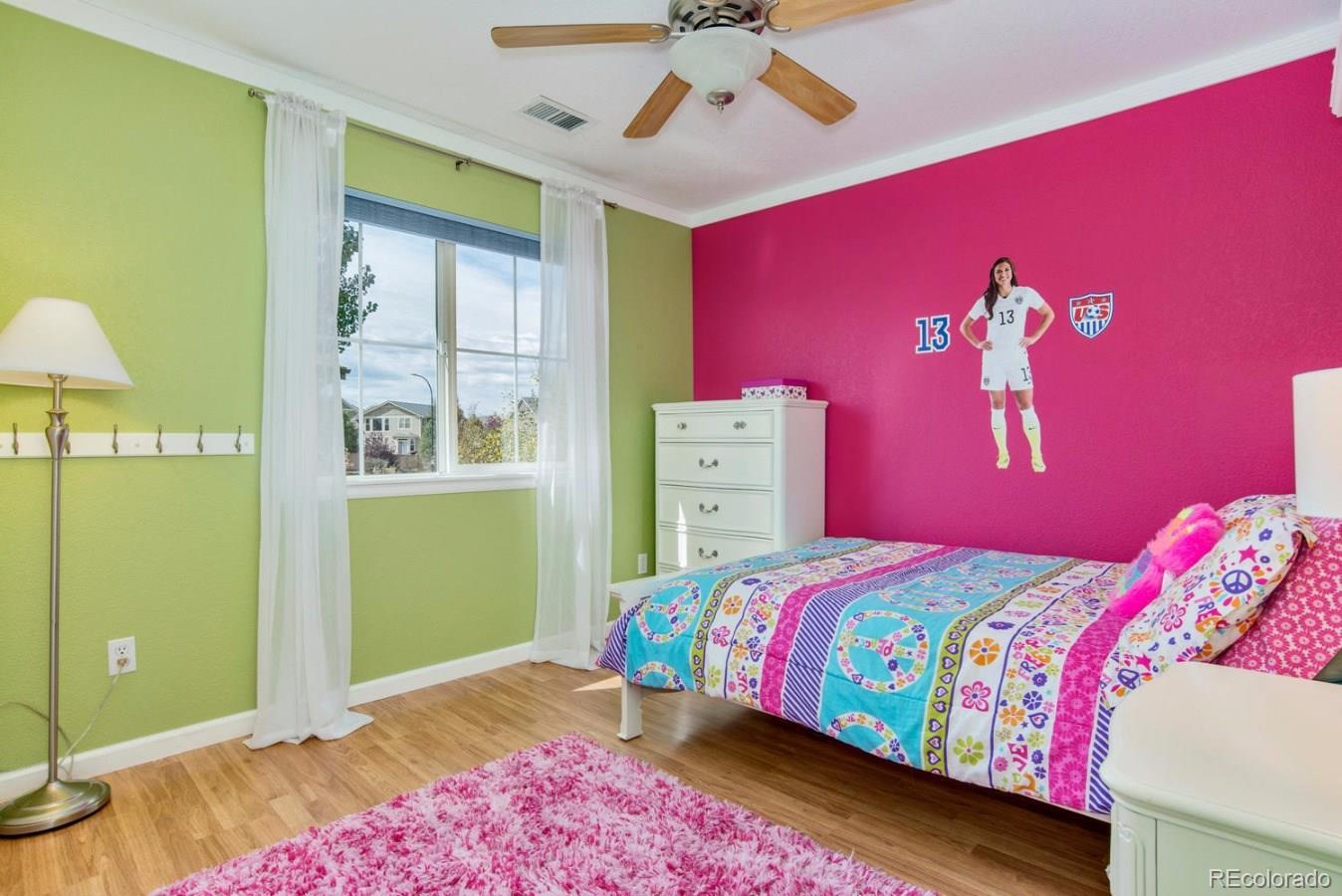 10685 Wynspire Road Highlands Ranch, CO 80130 - Photo 26 of 29 a bedroom with a bed and a chandelier