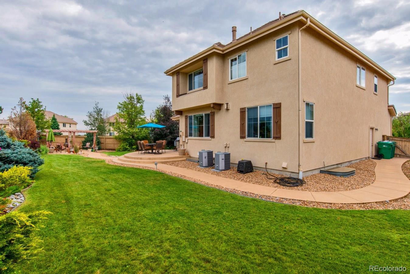 10685 Wynspire Road Highlands Ranch, CO 80130 - Photo 29 of 29 a front view of a house with garden