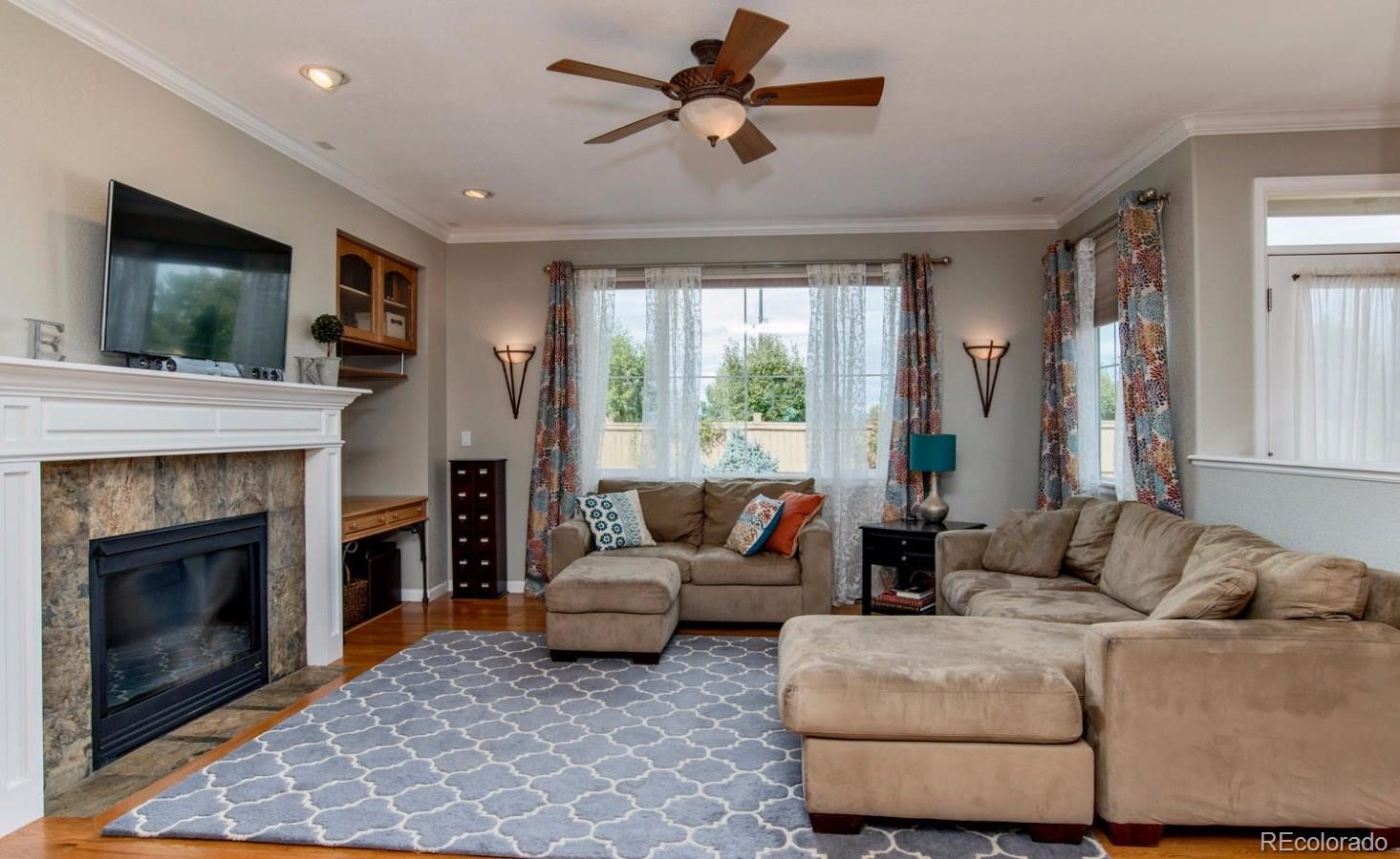 10685 Wynspire Road Highlands Ranch, CO 80130 - Photo 7 of 29 a living room with furniture and a fireplace