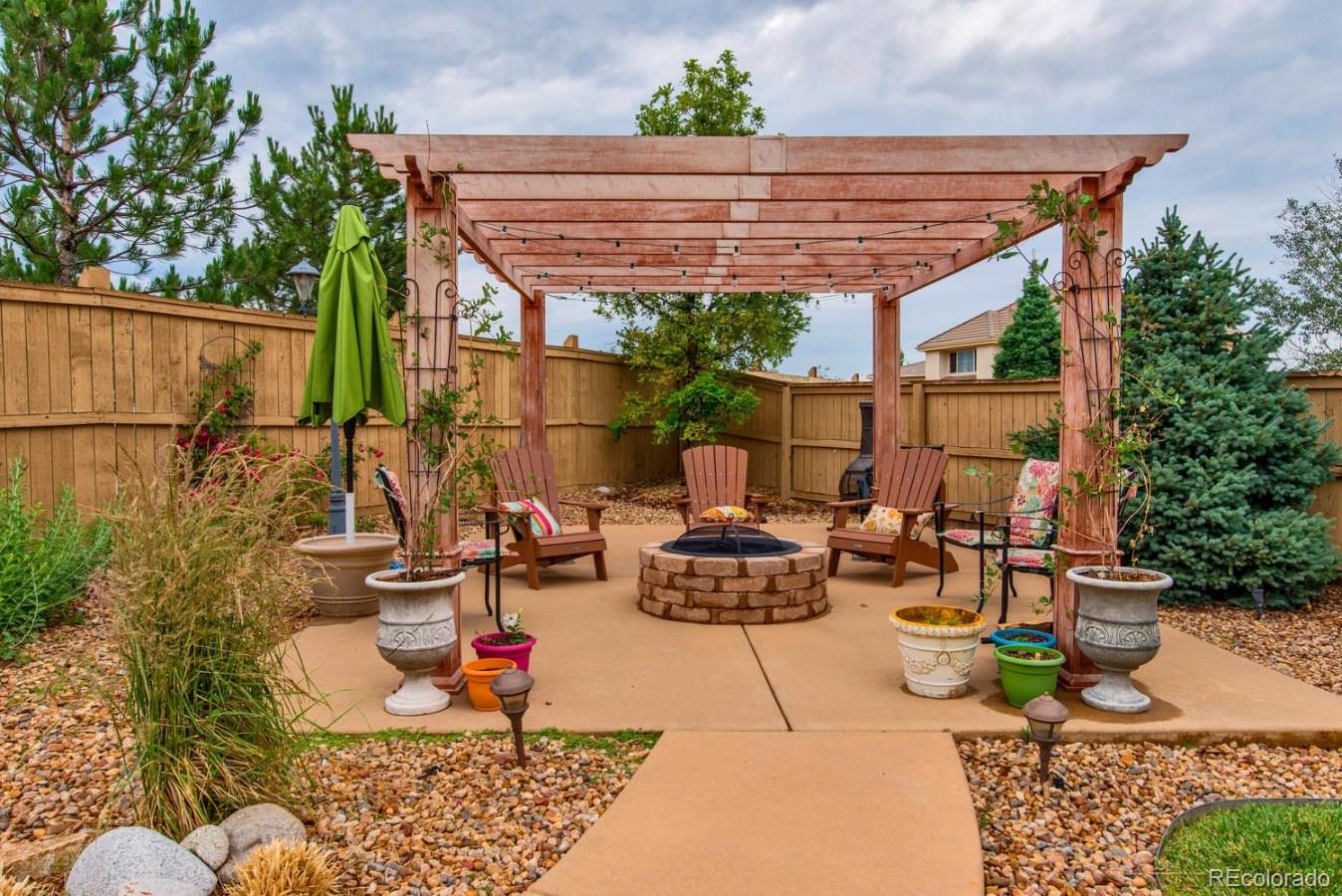 10685 Wynspire Road Highlands Ranch, CO 80130 - Photo 9 of 29 a backyard of a house with outdoor seating