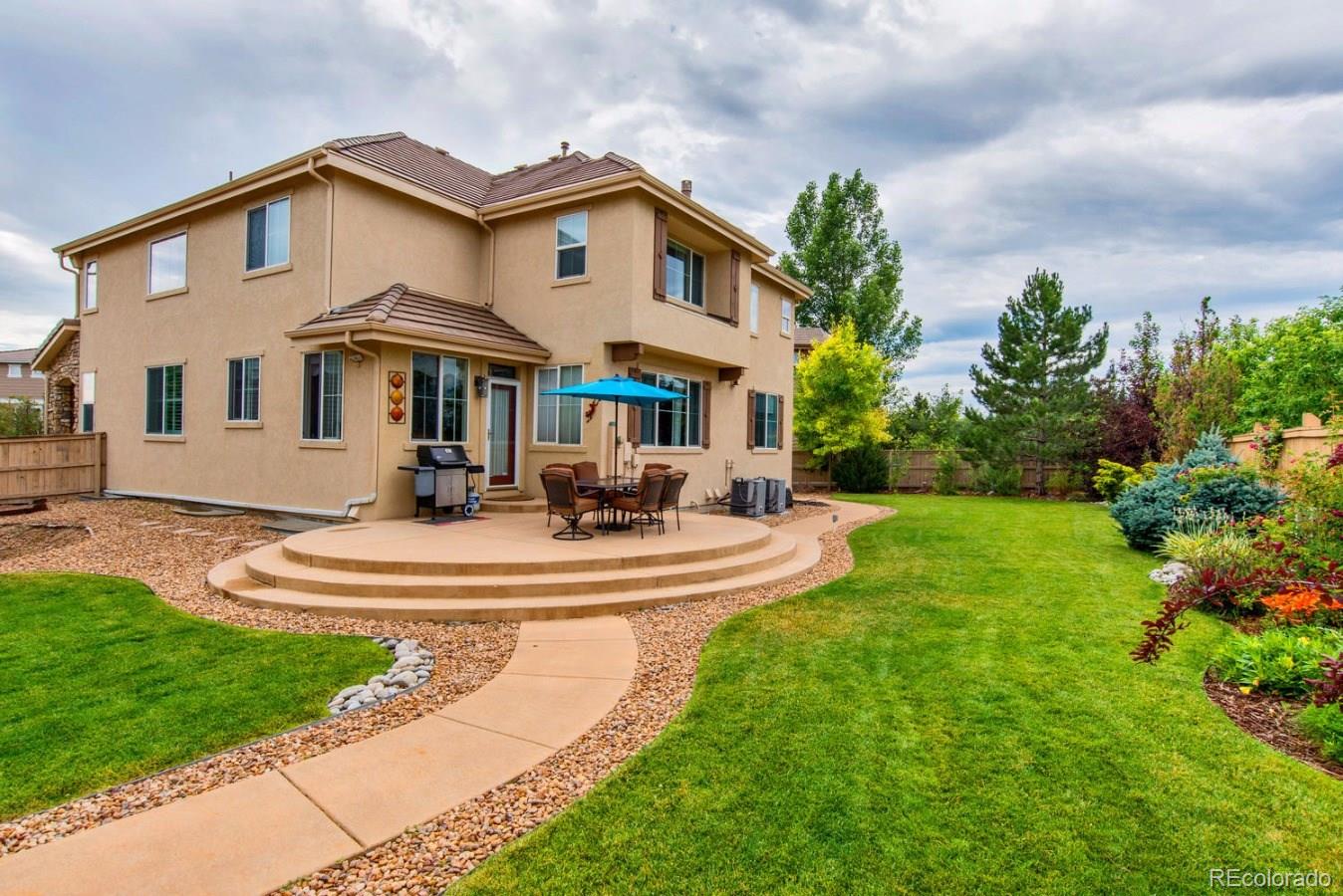 10685 Wynspire Road Highlands Ranch, CO 80130 - Photo 10 of 29 a front view of a house with a yard table and chairs