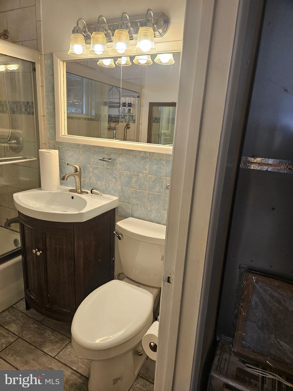 905 Lindsay Road Oxon Hill, MD 20745 - Photo 22 of 31 a bathroom with a toilet a sink and mirror