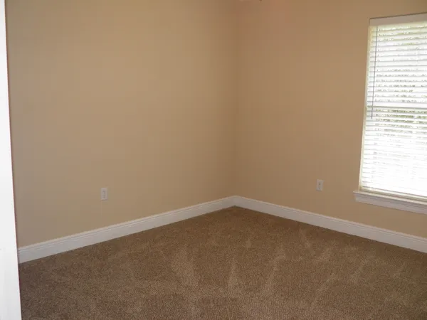a bedroom with bed and a window