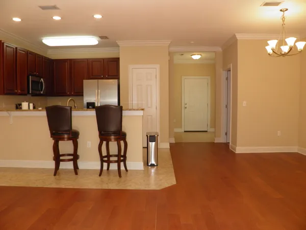 a kitchen with stainless steel appliances granite countertop a refrigerator and a stove top oven