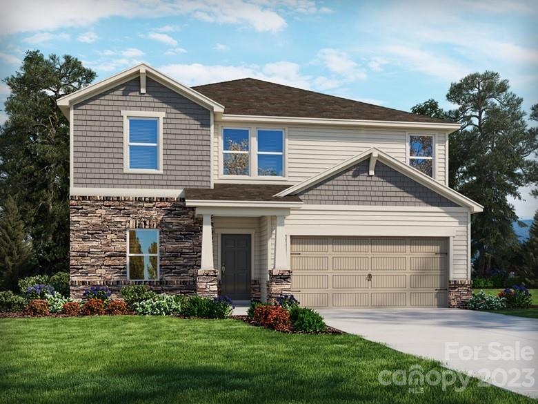 a front view of a house with a garden and yard