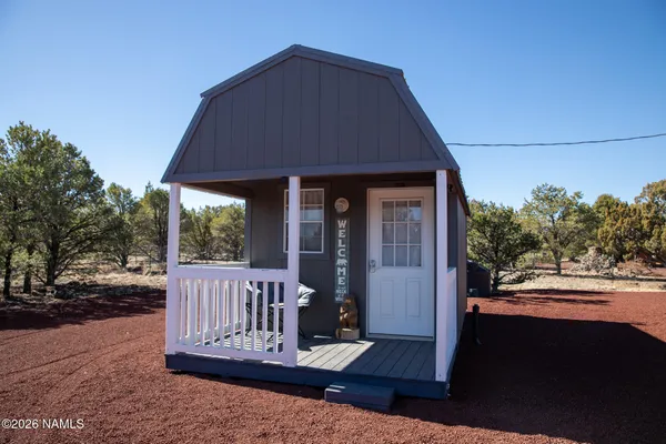 a view of a house with backyard and porch