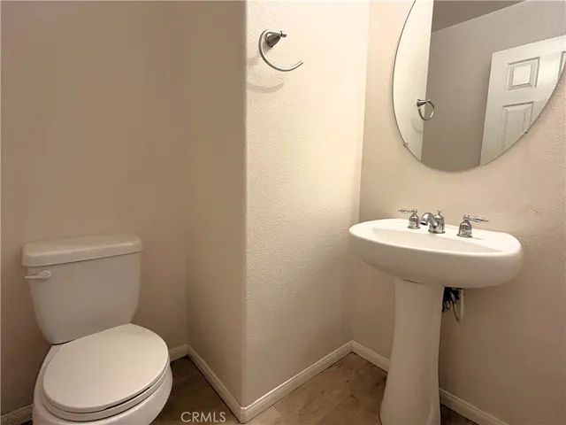 a white toilet sitting next to a bathroom sink