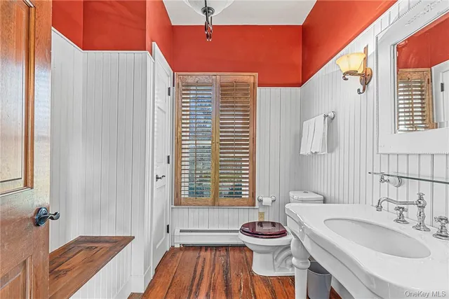 a bathroom with a sink a toilet a tub and shower