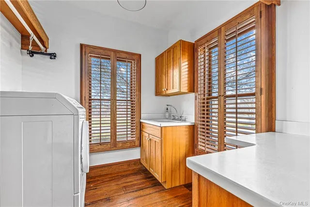 a spacious bathroom with a granite countertop sink and a large mirror