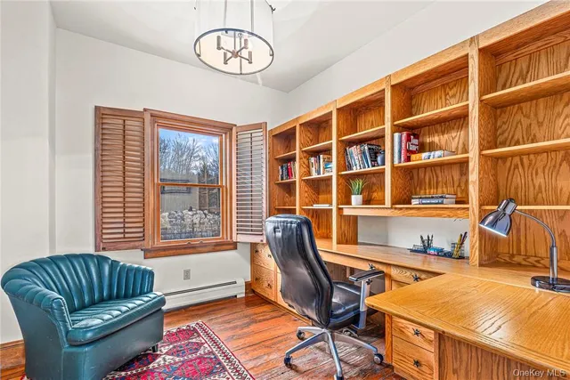 a livingroom with workspace and a couch