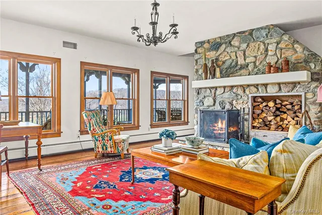 a living room with furniture a rug and a floor to ceiling window