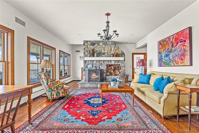 a living room with furniture a rug and a chandelier