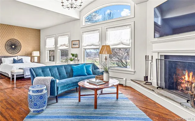 a living room with a bed furniture and a window