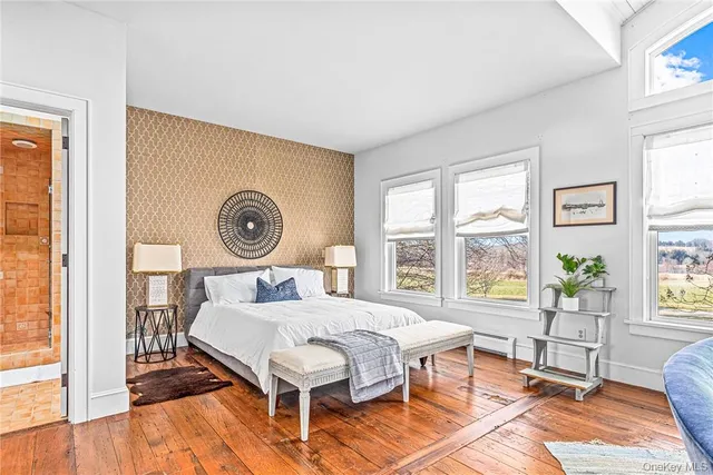 a spacious bedroom with a bed and a window