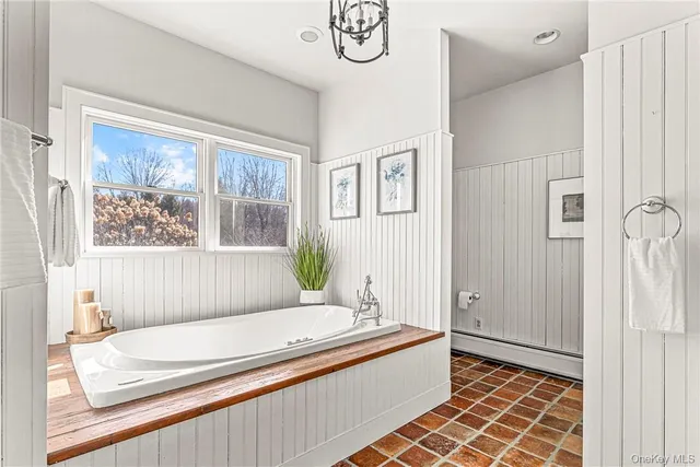 a bathroom with a granite countertop toilet a sink a mirror and shower