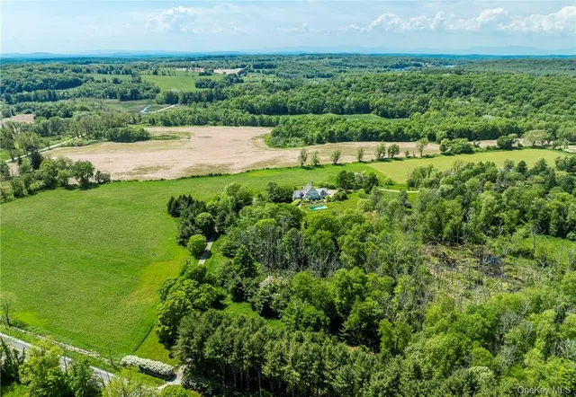an aerial view of house with yard and swimming pool