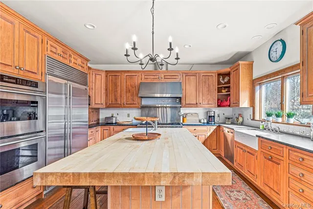 a large kitchen with lots of counter space and stainless steel appliances
