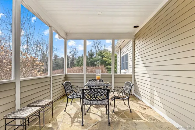 a balcony with chairs and table