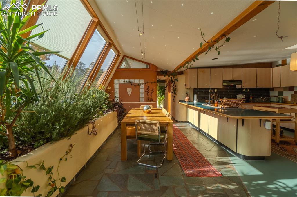 17160 Goshawk Road Colorado Springs, CO 80908 - Photo 11 of 43 a kitchen with stainless steel appliances kitchen island granite countertop a stove and white cabinets