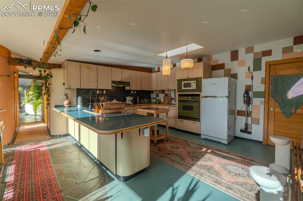 17160 Goshawk Road Colorado Springs, CO 80908 - Photo 12 of 43 a kitchen with stainless steel appliances granite countertop a refrigerator a sink and a stove